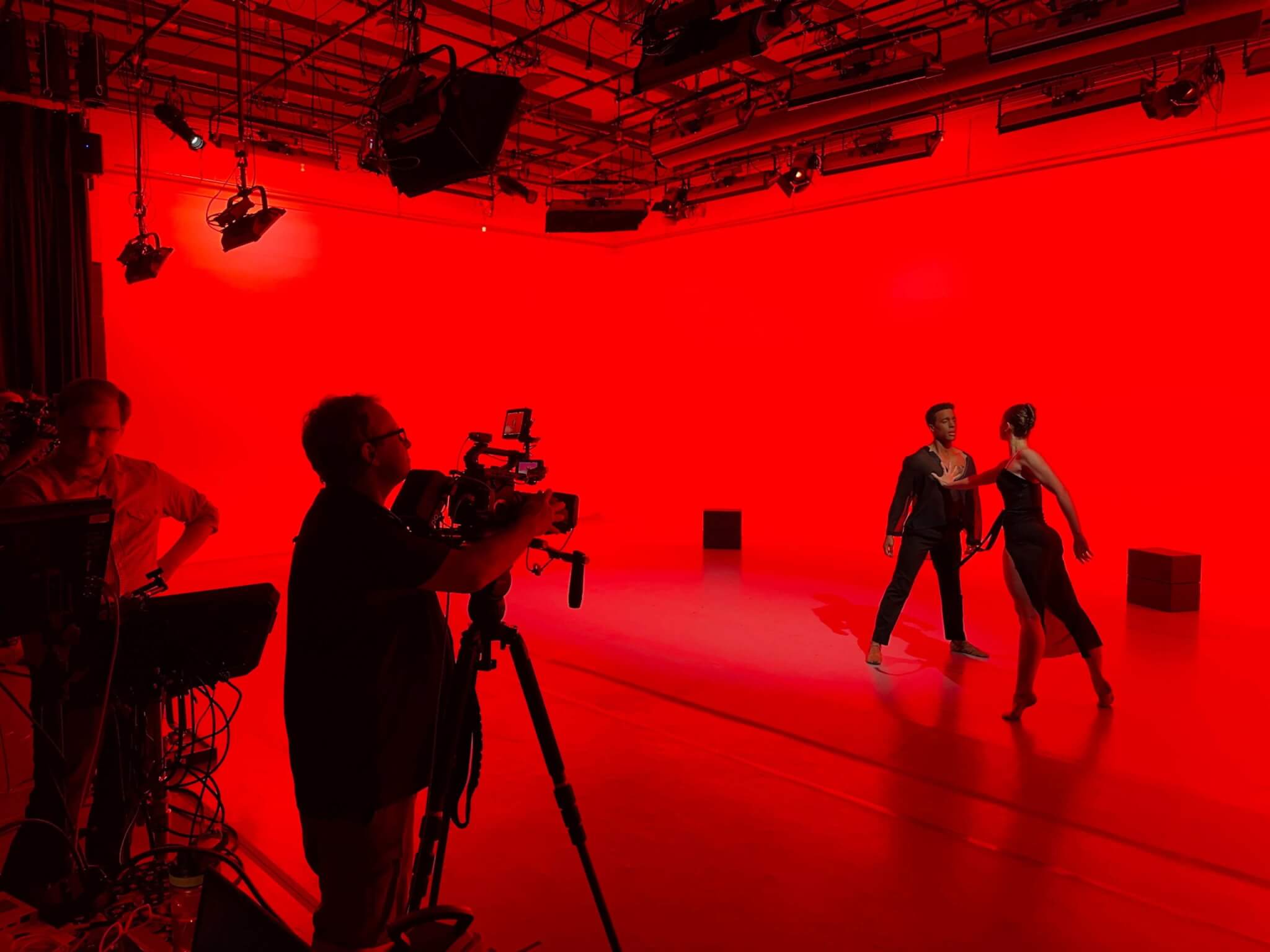 ballerinas perform for camera in mood lighting